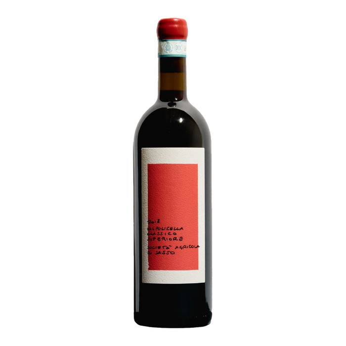 Red wine bottle with red cap and white label on dark glass, red label panel