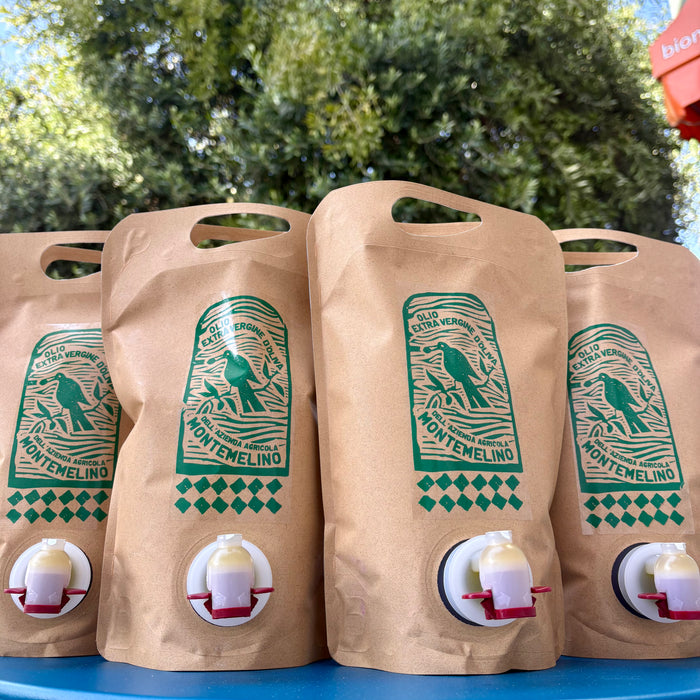 Extra virgin olive oil bag set with hand-pour spout and Montemelino label, kraft paper
