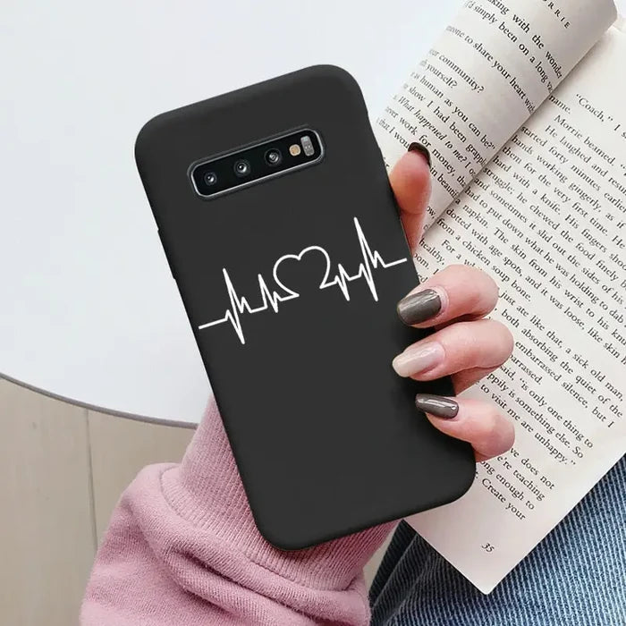 a woman holding a book and a phone case