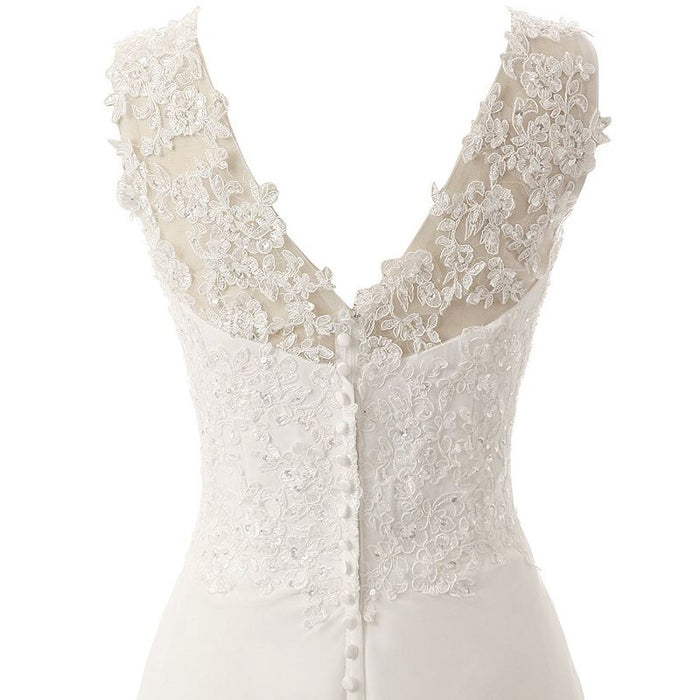 Elegant affordable simple wedding dress for bride featuring delicate lace detailing and button closure
