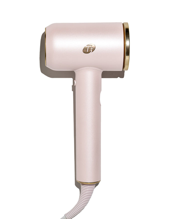 Pink hair dryer with gold accents on a white background