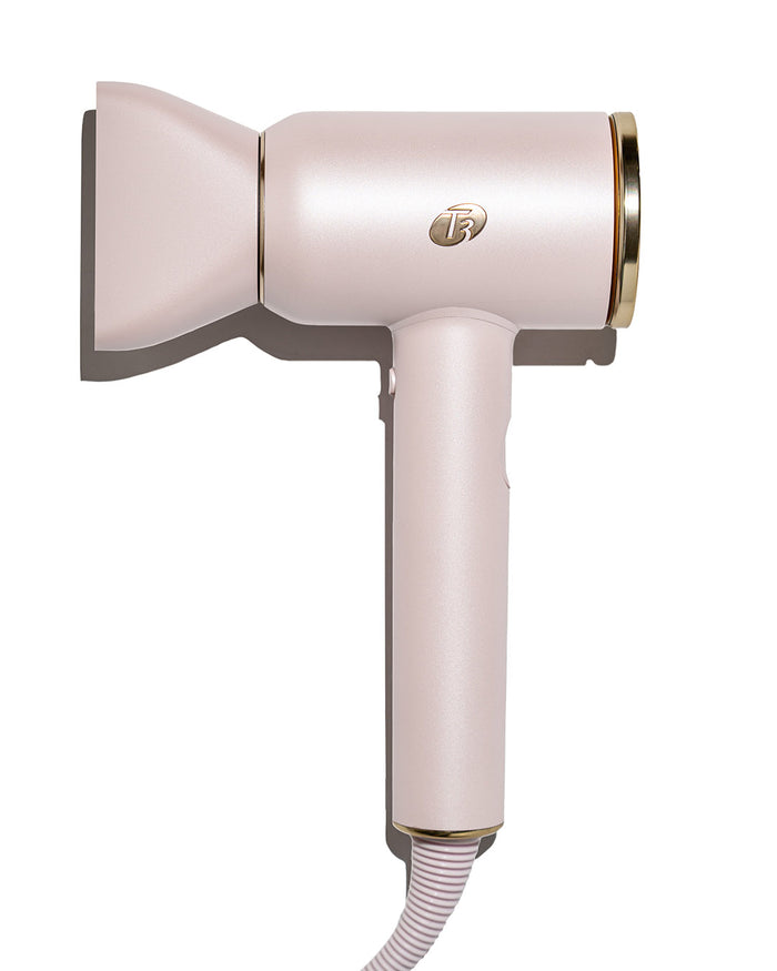 Pink hair dryer with gold accents on a white background