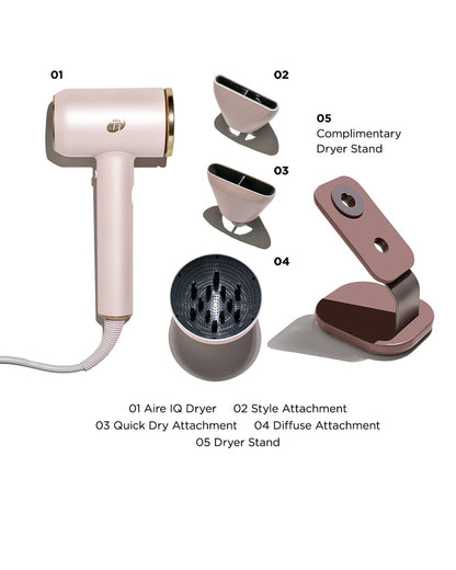 Pink hair dryer set with attachments and stand on a white background