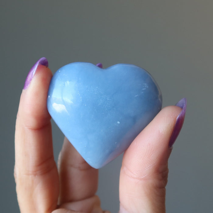 hand holding angelite heart