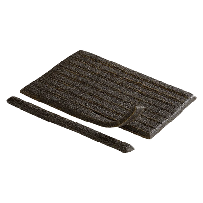 A close-up, angled view of the Captain Kush Rip Strips, showcasing their dark, rectangular shape against a neutral background.