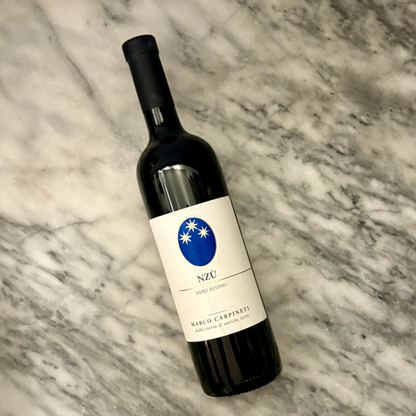 Carpineti Nzu Red 2020 wine bottle tilted, blue Nzu label