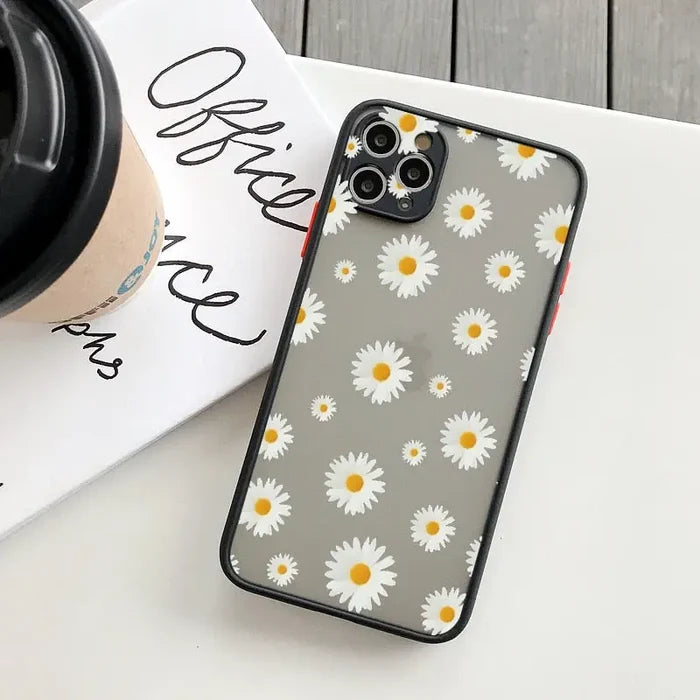 Daisy iphone case with a coffee cup on a table