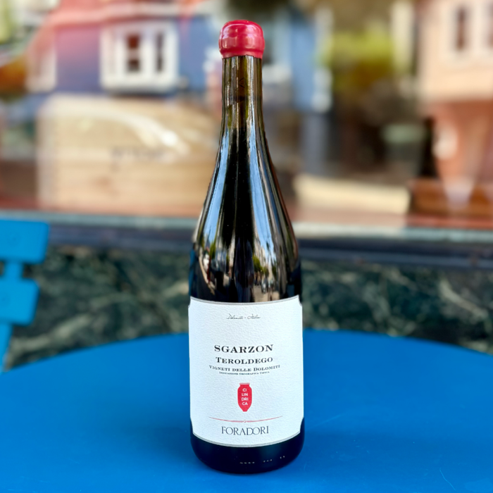 Foradori Teroldego Sgarzon wine bottle, 2021, red capsule on dark glass