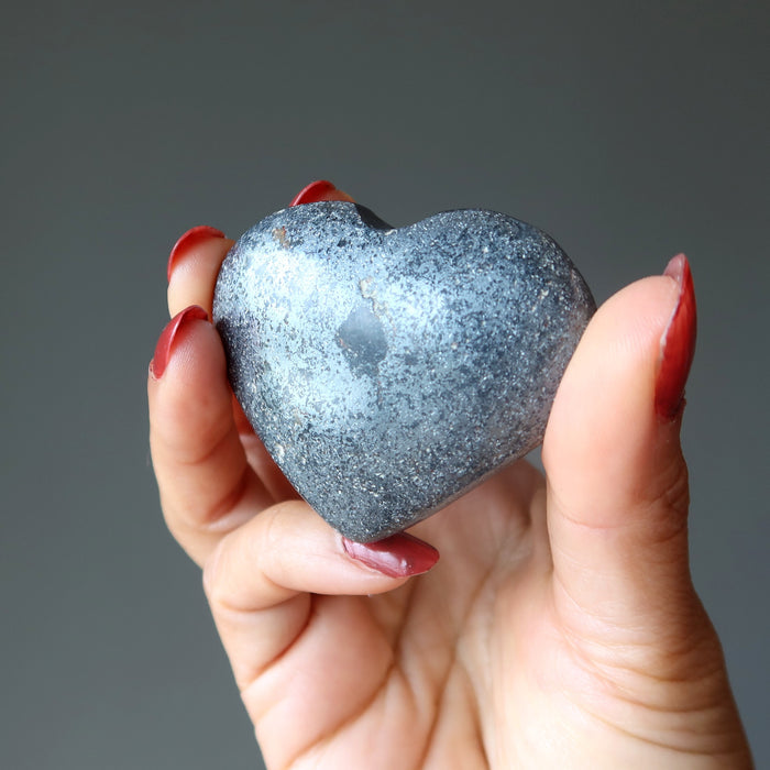 hand holding hematite heart