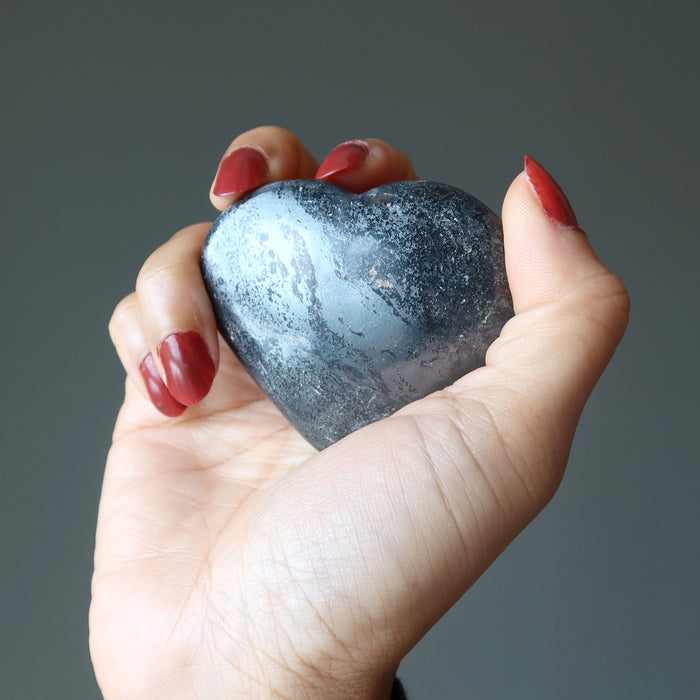 hand holding hematite heart