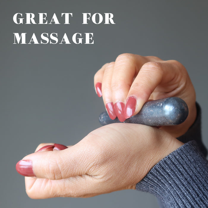 hand holding a hematite massage wand
