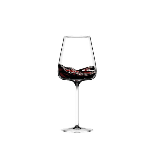 Stemmed wine glass with dark red swirling decoration on the bowl