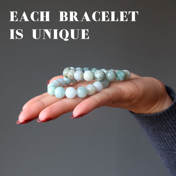 female holding jade bracelets in palm