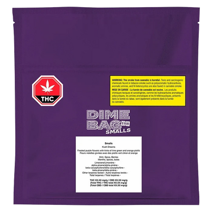 Close-up of the “Kush Dreams” package displaying bold text and a green cannabis leaf against a black background.