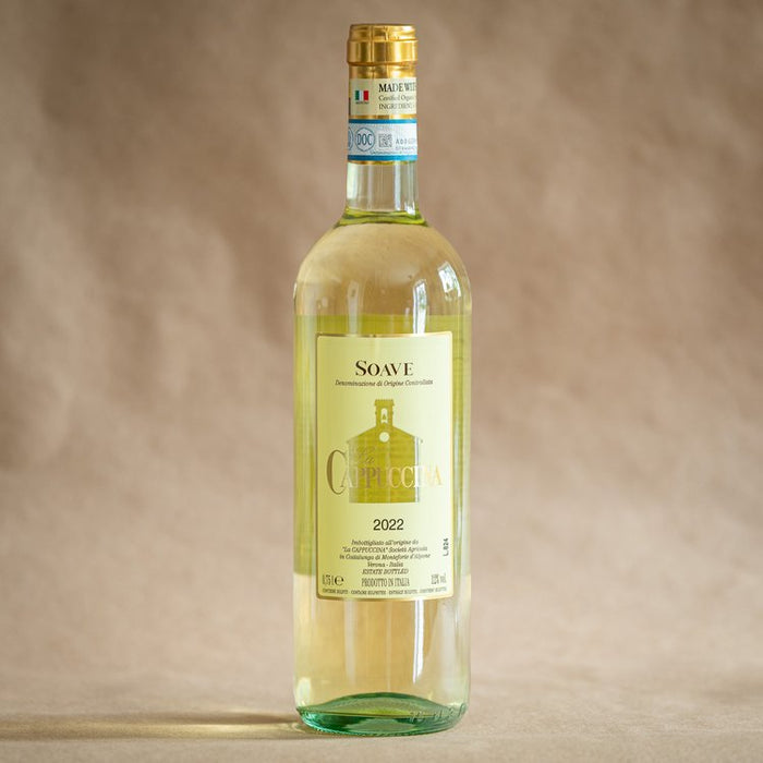 La Cappuccina Soave 2022 wine bottle, gold cap, pale straw glass, front label