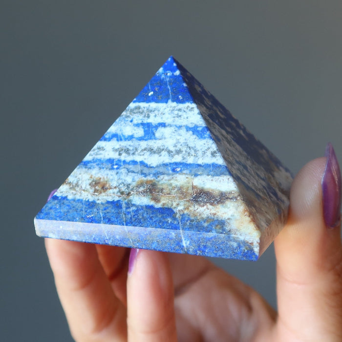 hand holding lapis pyramid