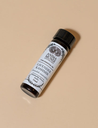 Roll-on bottle of Lavender Kashmir essential oil with a black cap on a beige background