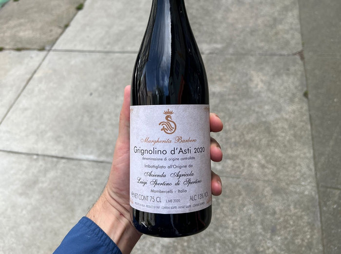 Wine bottle with dark glass and maroon label reading Grignolino d'Asti 2020