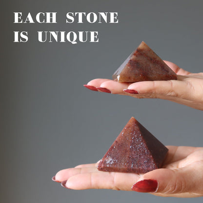 hands holding red aventurine pyramids to show each is unique