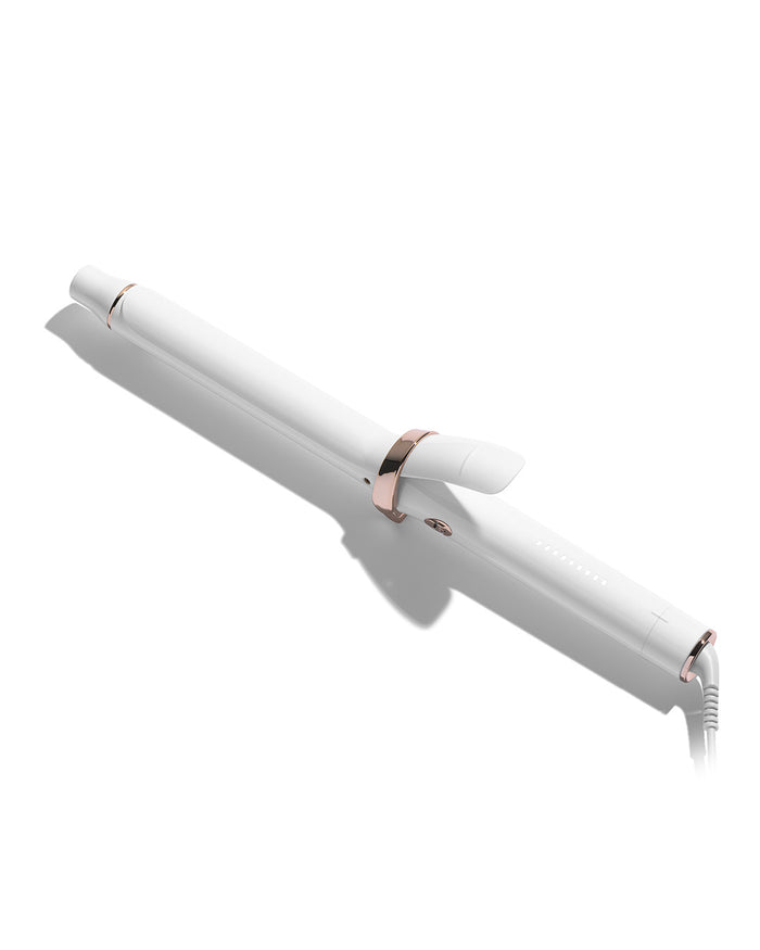 White hair curler with rose gold accents on a white background