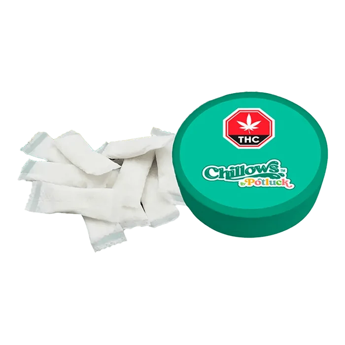 Overhead view of Wintergreen Chillows Pouches scattered on a white surface, capturing the texture and arrangement of the pouches.