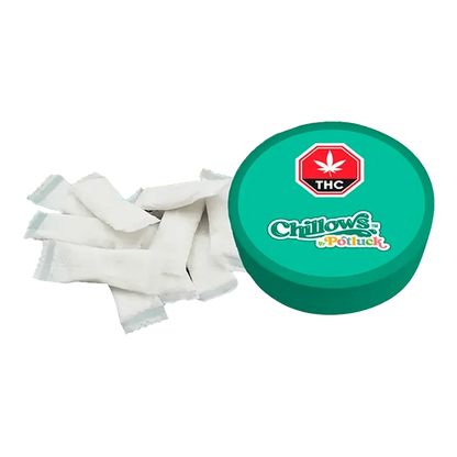 Overhead view of Wintergreen Chillows Pouches scattered on a white surface, capturing the texture and arrangement of the pouches.